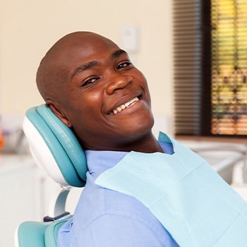 Man smiling while relaxing in treatment chair