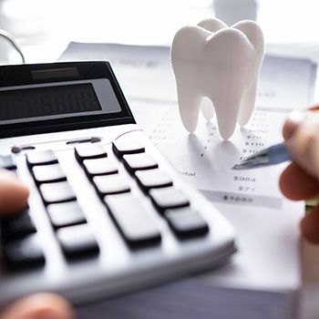 A patient calculating the cost of their dental care.